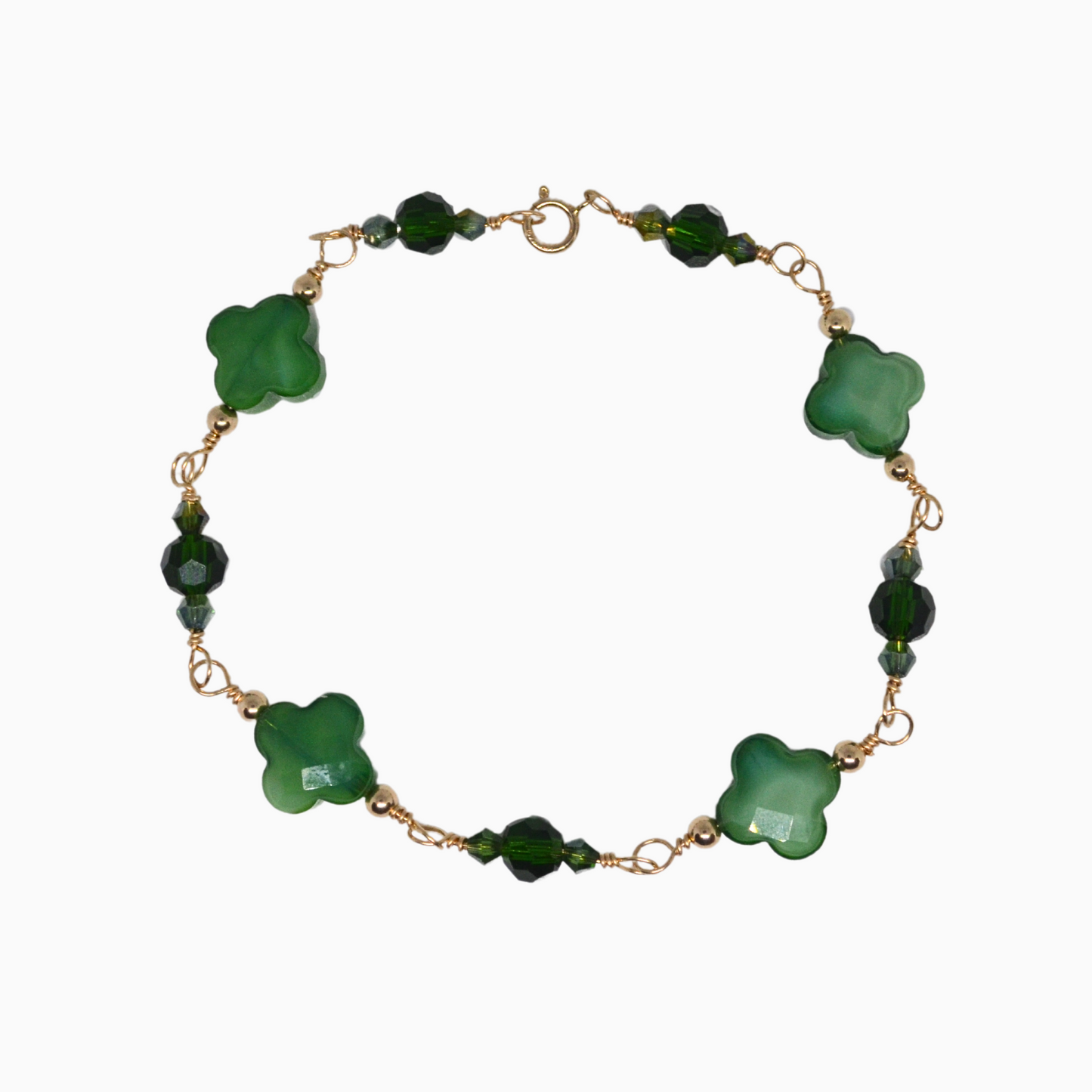 This stunning, handmade May birthstone bracelet is crafted with 14k gold-filled wire and features beautiful emerald-inspired glass crystals. The four-leaf clover charms add a touch of luck and good fortune. A perfect gift for any occasion, this bracelet is both stylish and meaningful.