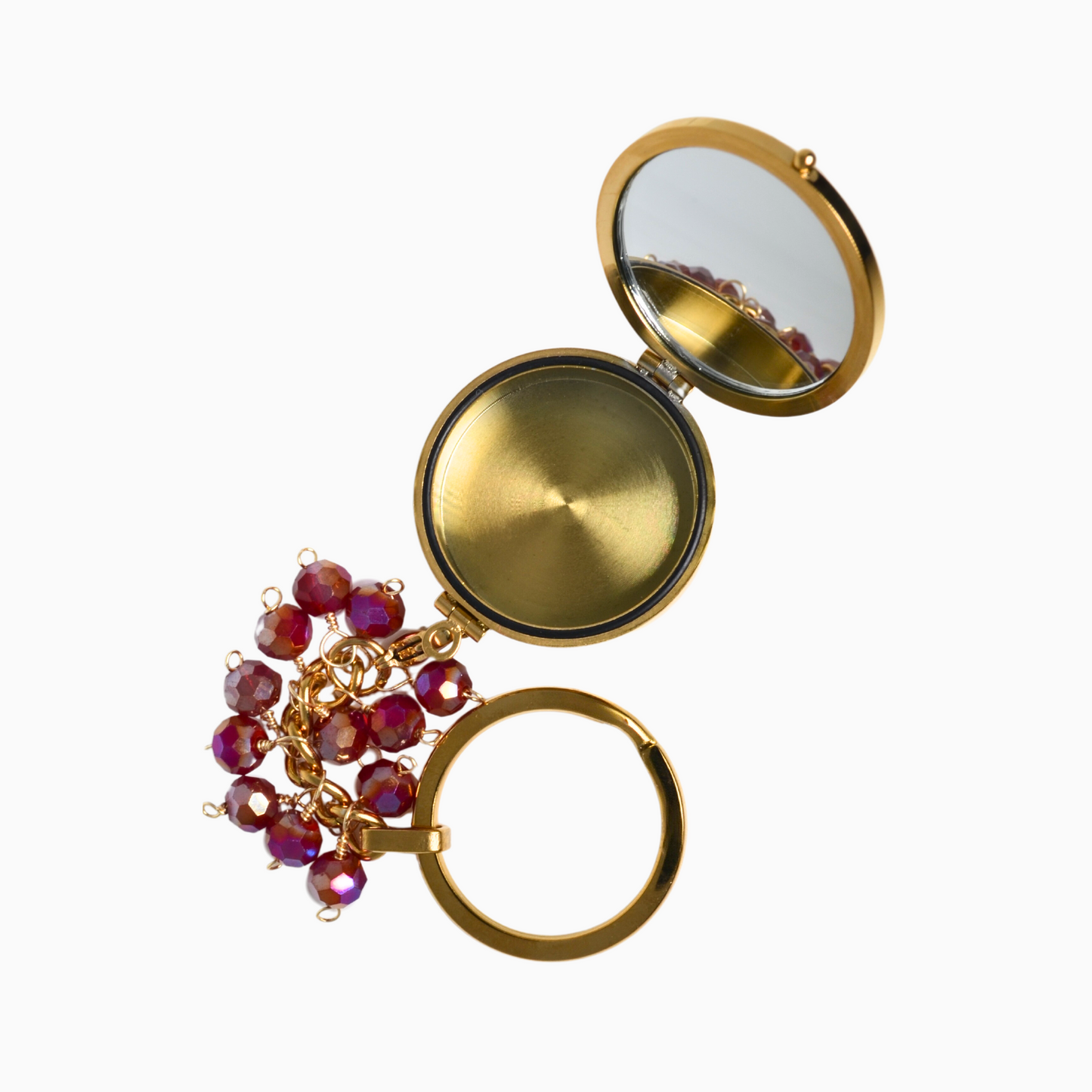 January Birthstone Pocket Locket opened to reveal its sleek interior, showcasing a built-in mirror. The locket features a rich red glass crystal, symbolising passion and protection, with a compact compartment for storing small essentials.