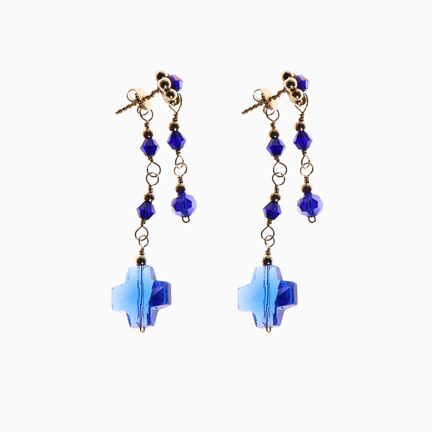 Blue sapphire stud earrings featuring a stunning flower-like crystal centrepiece, luxe 14k gold-filled spacer balls, and dangling sapphire-inspired bicone crystals. A 14mm cross charm adds a meaningful touch.