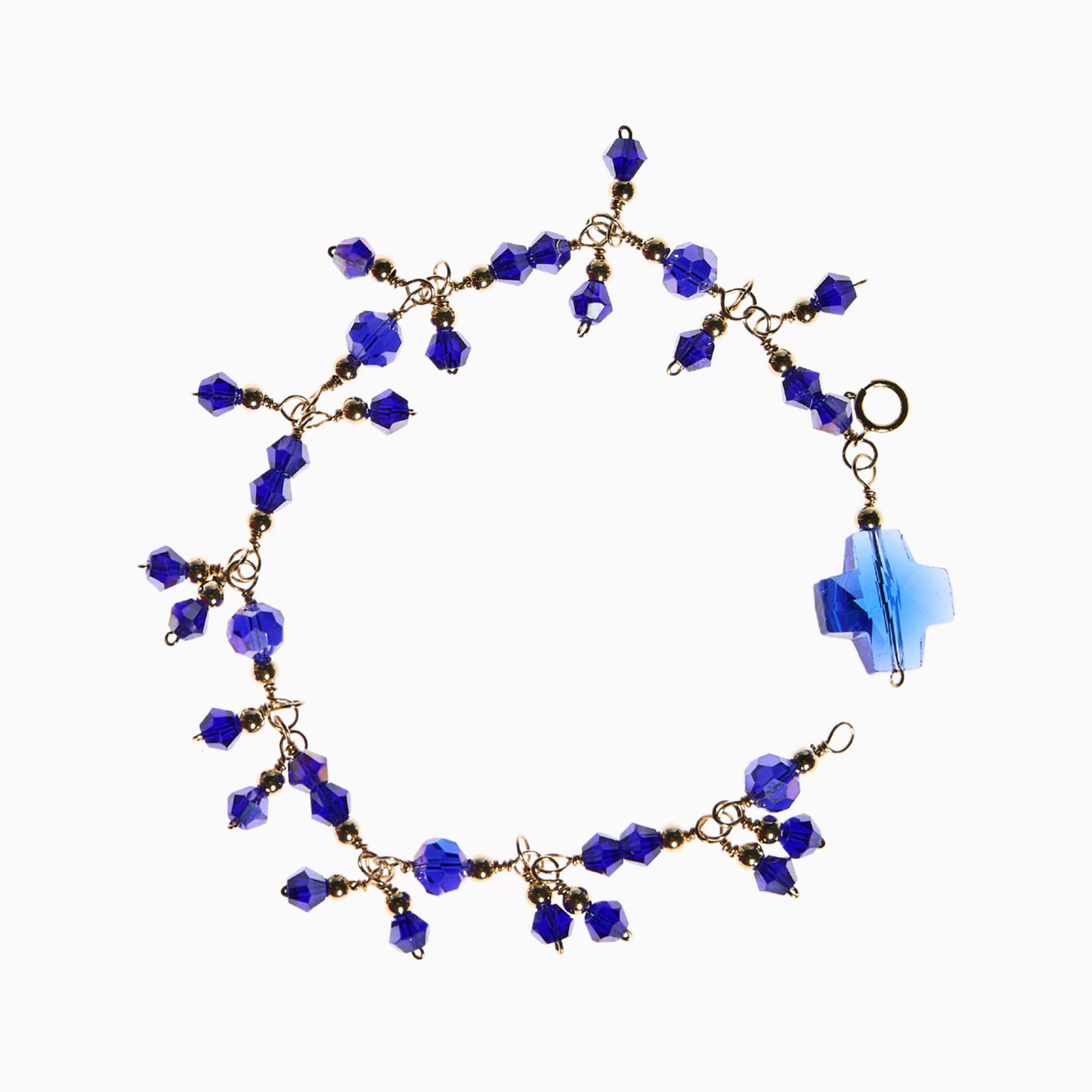 Blue Sapphire bracelet made with 14k gold-filled wire, featuring stunning sapphire-inspired 4mm bicone and 6mm round glass crystals, with 14k gold-filled spacer balls for a refined finish. A 14mm cross-shaped charm adds a meaningful touch.