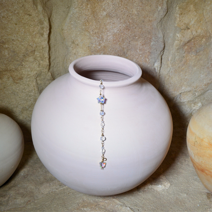 Handcrafted April birthstone bracelet featuring 14k gold-filled materials, radiant glass crystals, and a dangling butterfly and star crystal, displayed elegantly hanging in a ceramic vase. Perfect for gifting on birthdays, anniversaries, or special occasions, symbolising clarity, strength, and brilliance.