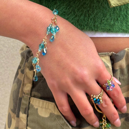 This shows how the March Birthstone Aquamarine water teardrop crystal bracelet looks like when wearing it outside in normal outside lighting. 