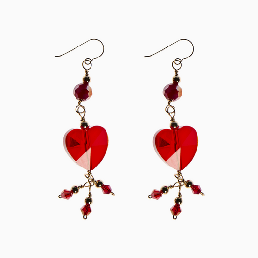 Elegant handcrafted earrings featuring a 14mm heart crystal, 6mm round crystal, and 3mm bicone crystal in deep garnet hues. Designed with 14k gold-filled materials, these earrings embody strength, passion, and timeless beauty.