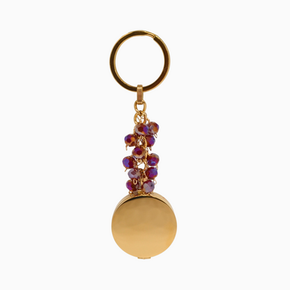 Stylish Garnet Pocket Locket Keychain made of gold stainless steel, featuring a rich red glass crystal that symbolises passion and protection. Includes a built-in mirror and compartment for storing small essentials like lip balm or keepsakes. A perfect accessory for January birthdays or those who love bold, vibrant colours.