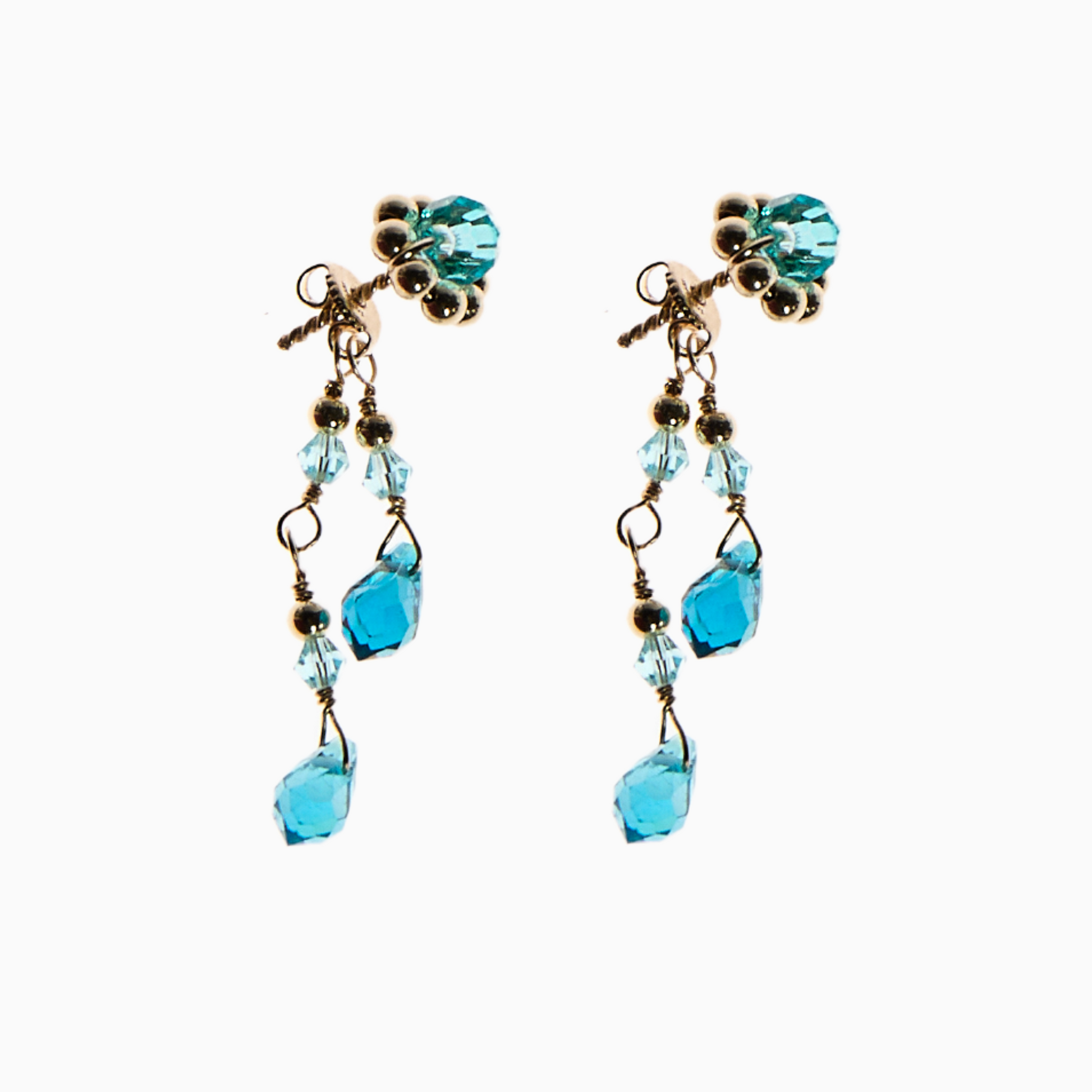 March earring featuring central flower surrounded by 14k gold-filled spacer balls, dangling crystals, and teardrop-shaped crystals in two shades of blue, they’re inspired by the sea’s gentle waves. The unique clasp, accented with crystals and teardrops, adds extra sparkle.